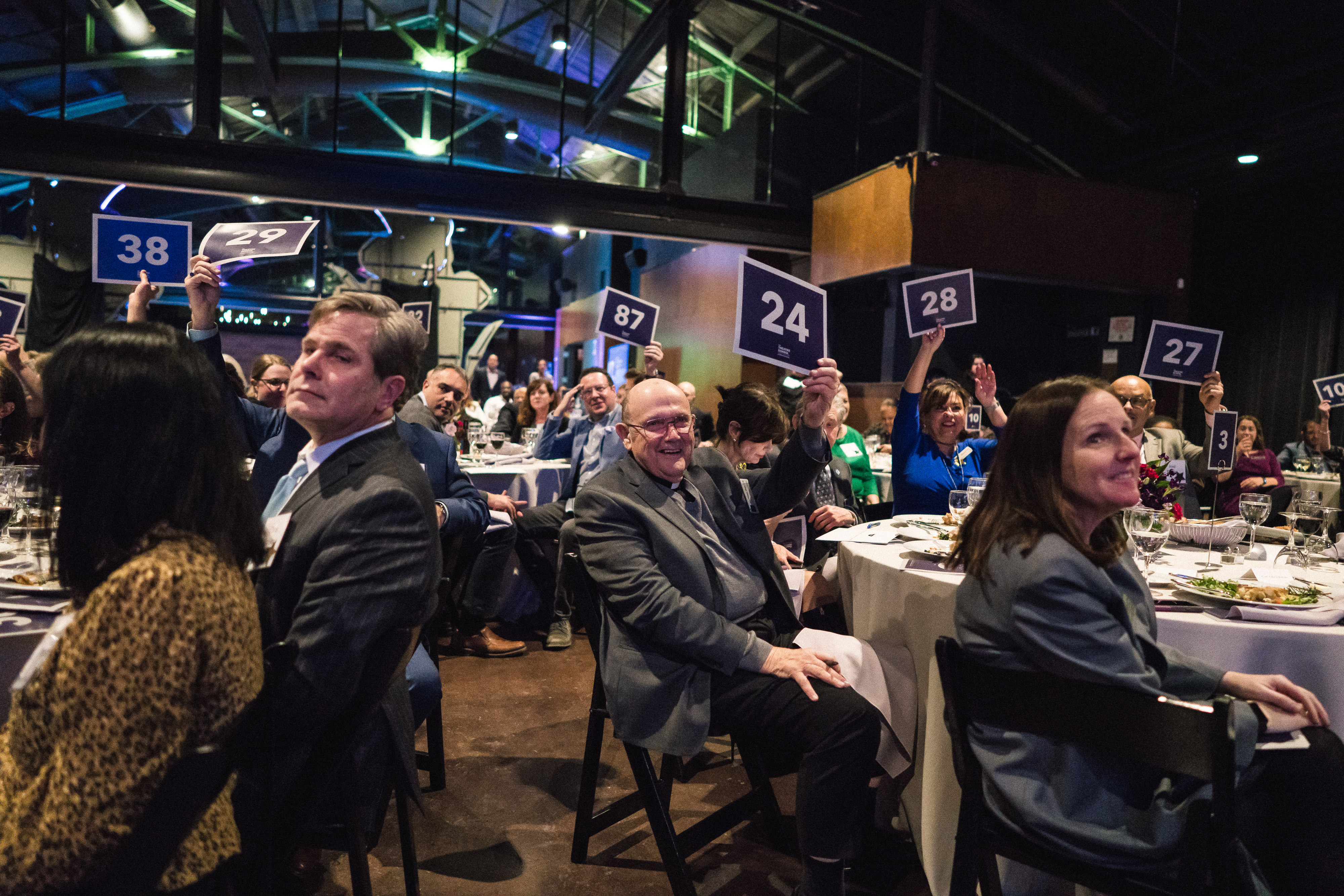 Gala attendees bidding during the Fund-the-Need auction.